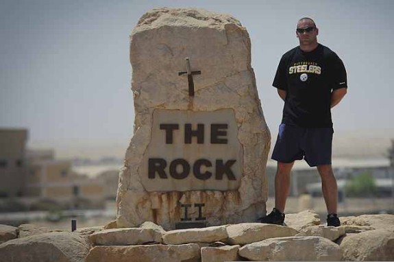 U.S. Air Force Tech. Sgt. Stentsen Ellenburg, a Pittsburgh Steelers fan, poses for a photo in anticipation of the upcoming NFL regular season kickoff Aug. 25, 2013, at the 386th Air Expeditionary Wing's Rock 